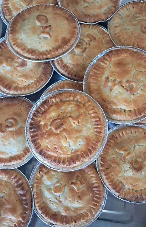 Baked pies in foil cases, filling codes stamped on the crusts