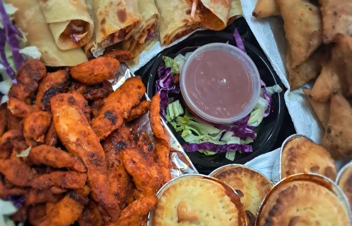 A hotel-range platter with samoosas, pies, spring rolls and chicken wings