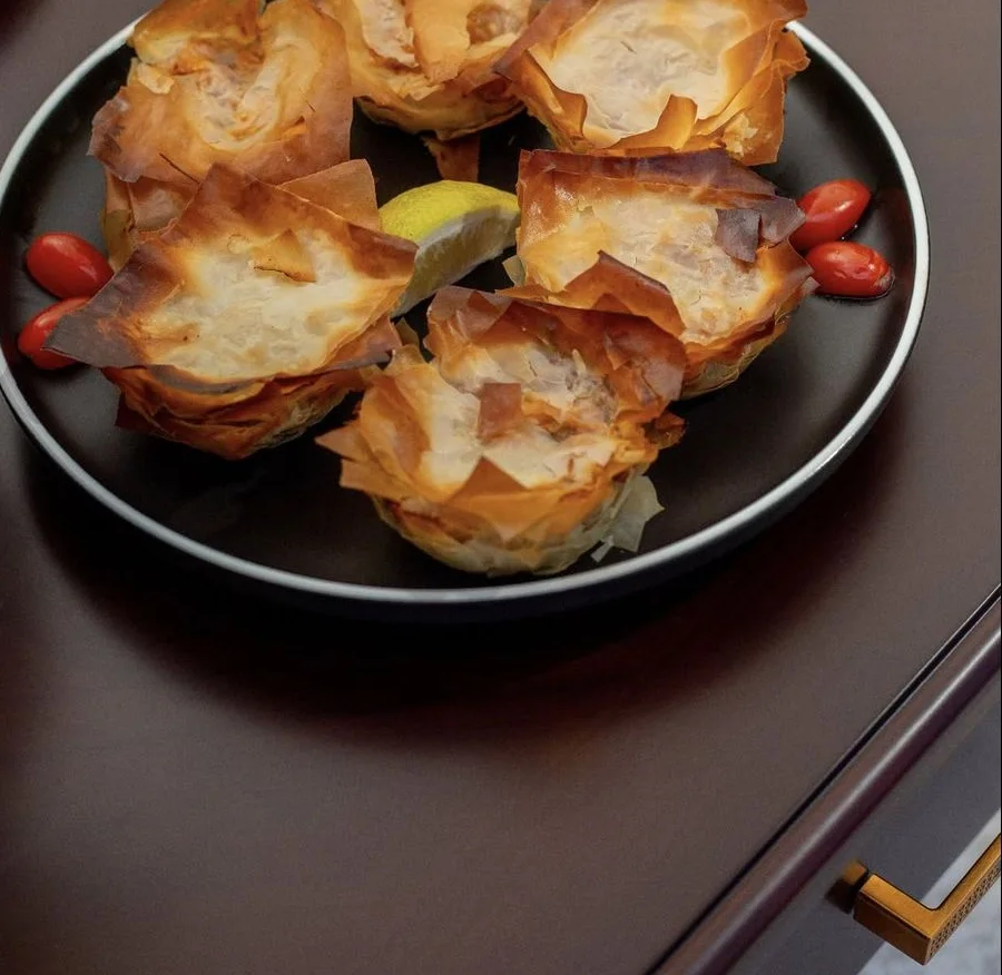 Phyllo pastry parcels on a dark plate