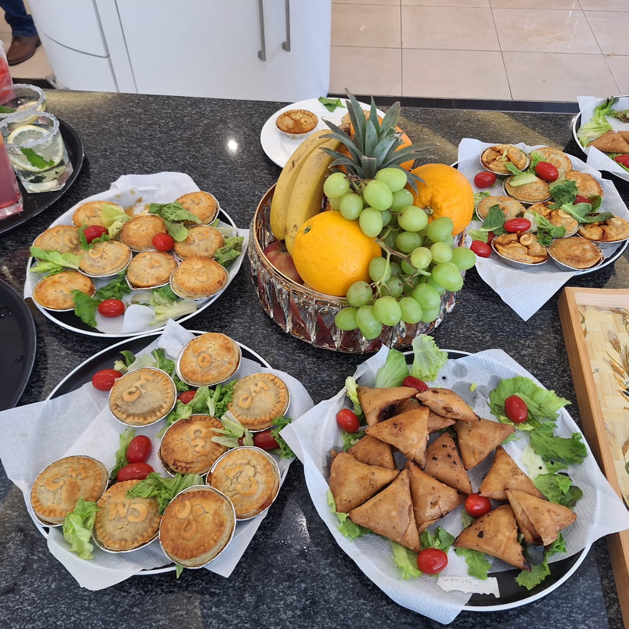 Vidhyas catering platter with pies, samoosas and fresh fruit