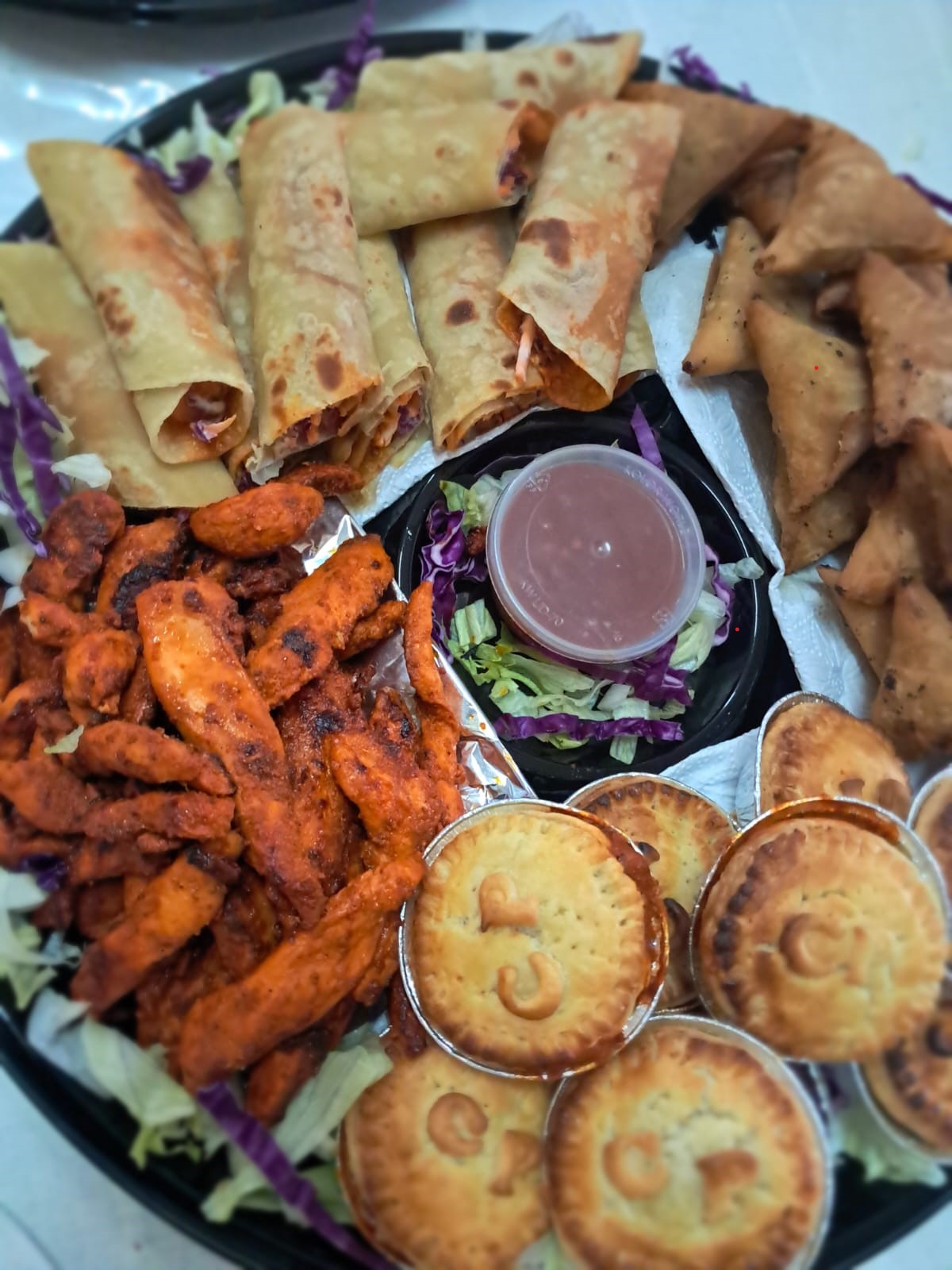 Vidhyas catering platter with phyllo rolls and pies